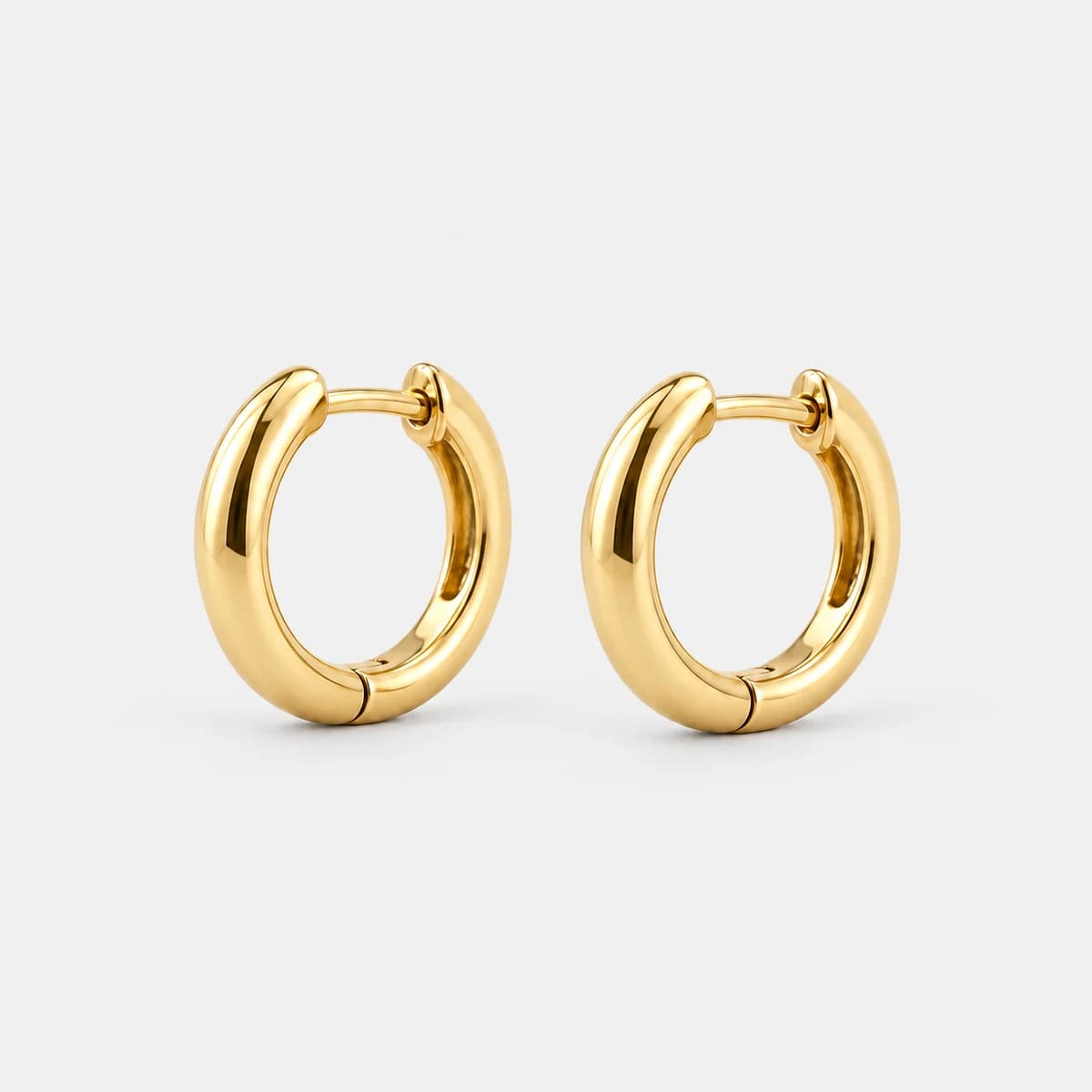 Micro Huggie Hoops, Stainless Steel — studio view